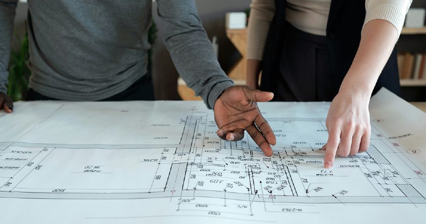 Building plans and people working through drawings